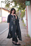 Woman wearing a black salwar set on a street with 'ek ping' branding.