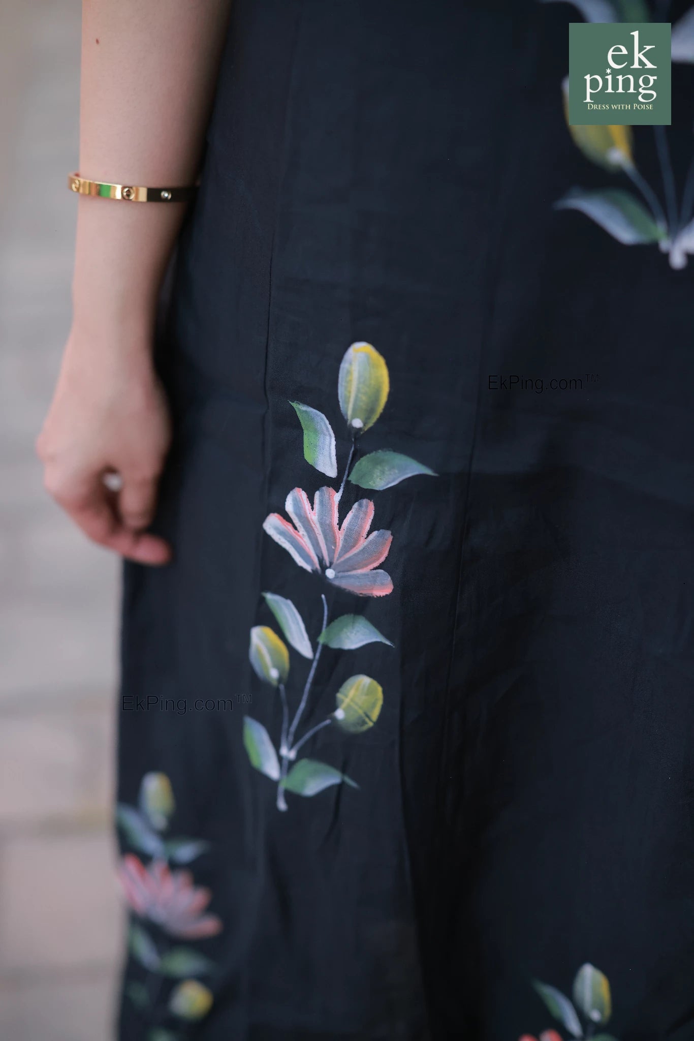 Black dress with floral embroidery on a blurred background