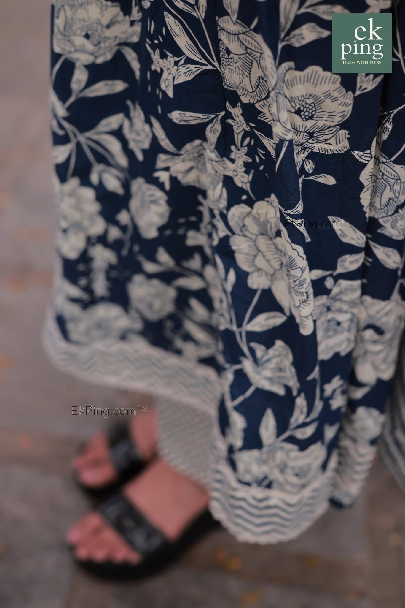 Navy blue pants with white floral pattern worn by a girl, brand 'ek ping' visible.