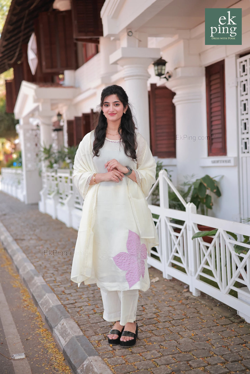 Girl wearing Chanderi Off-White Salwar Set with matching Dupatta in front of a colonial bunglow in fort kochi