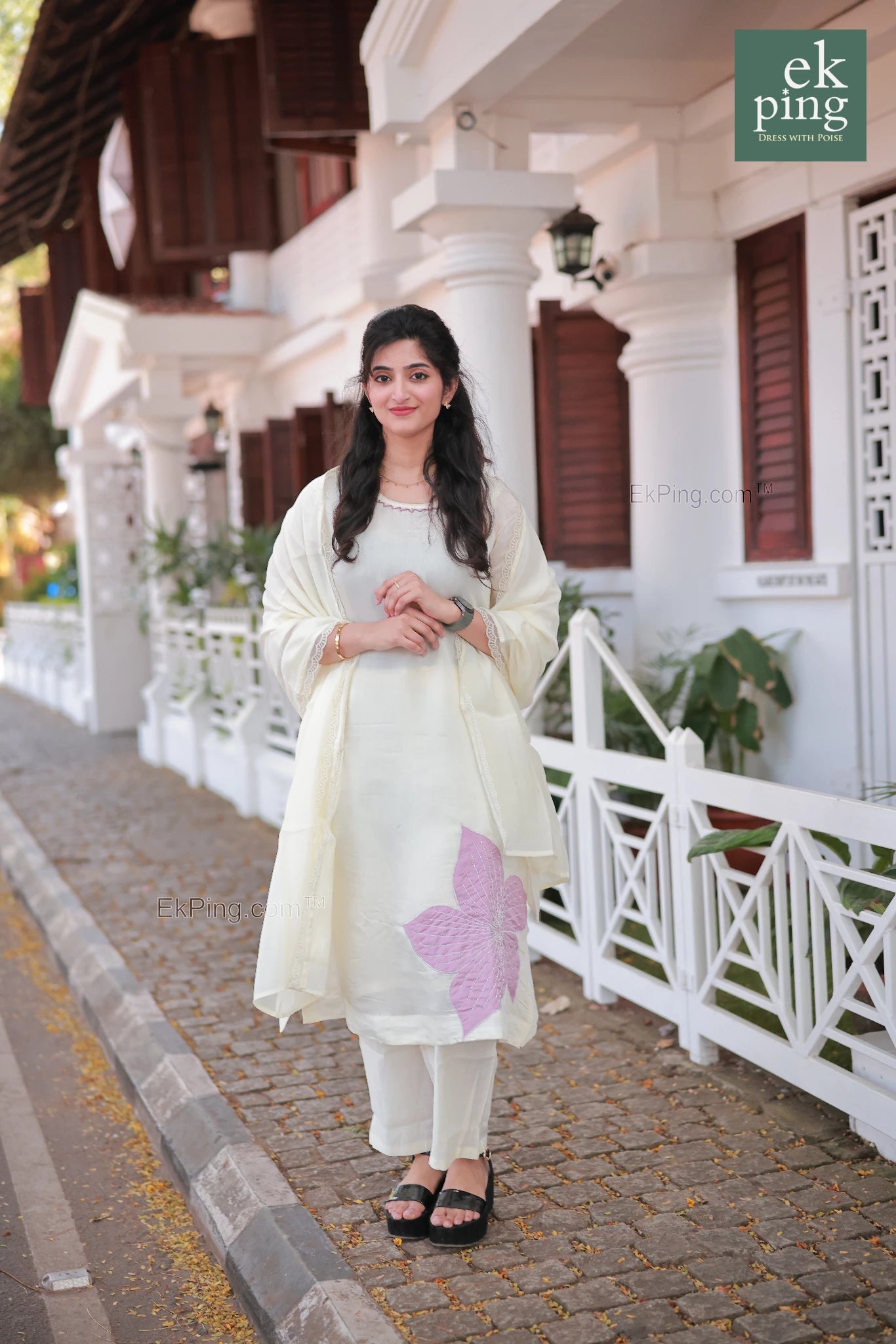 Girl wearing Chanderi Off-White Salwar Set with matching Dupatta in front of a colonial bunglow in fort kochi