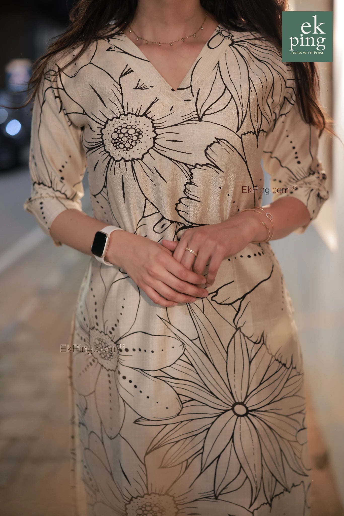 Girl in cream floral office wear kurti on street fort kochi with smart watch