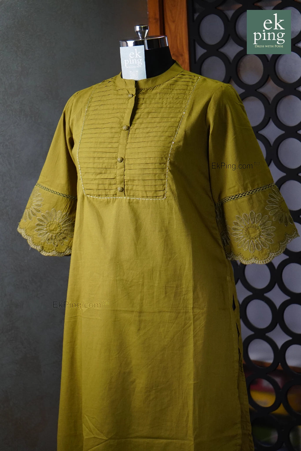 Green Co-ord set on a mannequin against a patterned wall with 'ek ping' branding.
