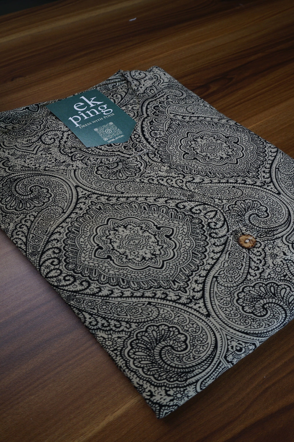 Plus size office wear kurti in grey pattern on a wooden surface