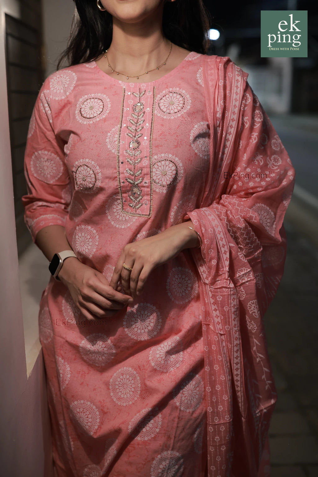 Girl wearing a pink cotton salwar set with a matching dupatta, on street