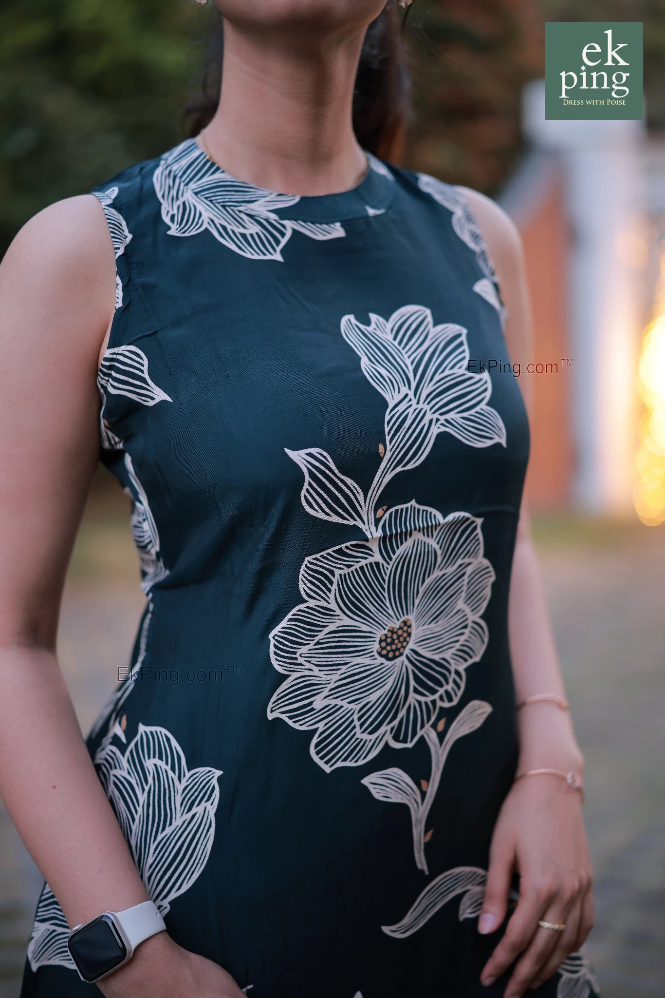 Woman wearing a sleeveless office wear with white floral patterns, blurred background