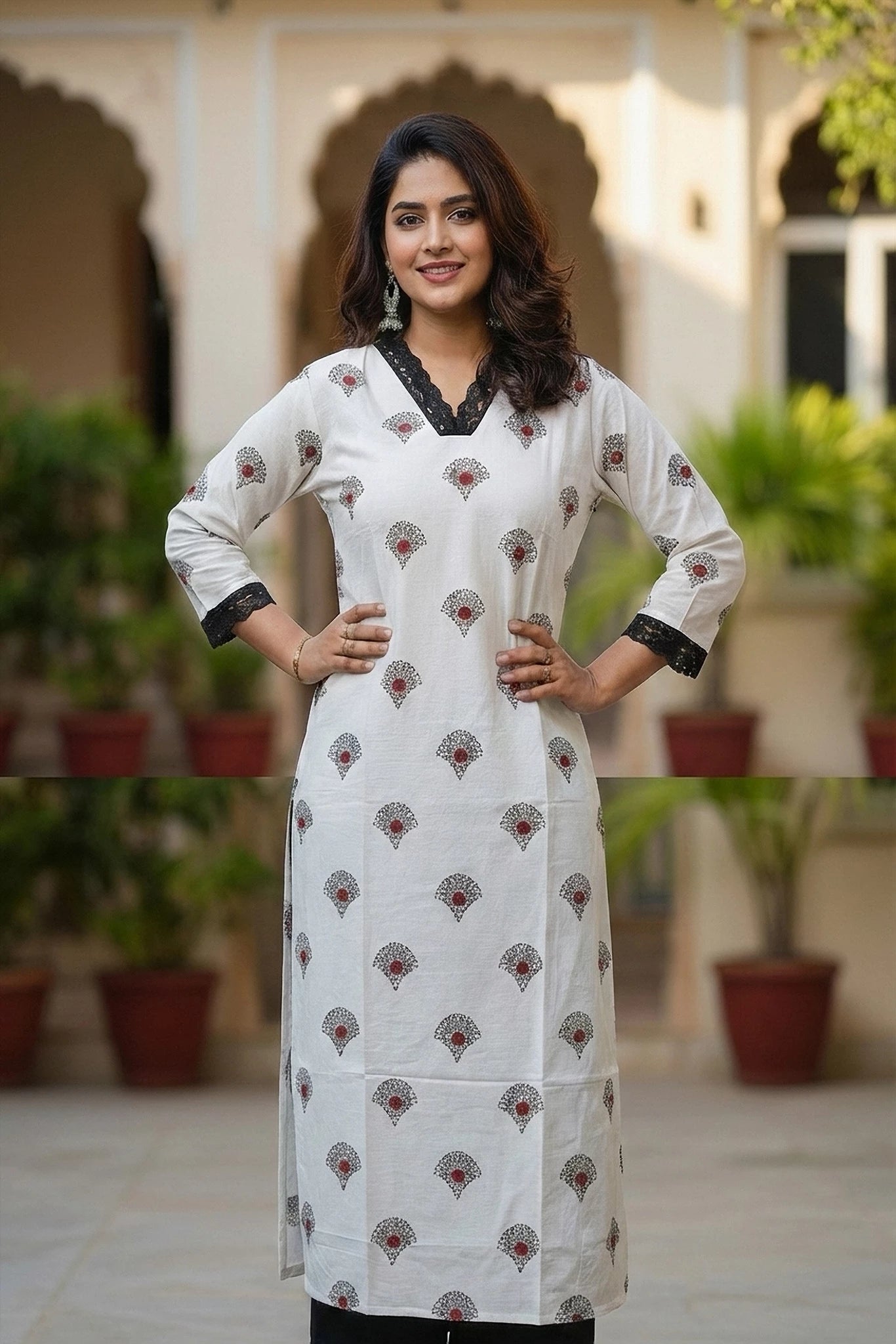 Woman wearing a white kurti with black and red patterns suitable for ofice wear
