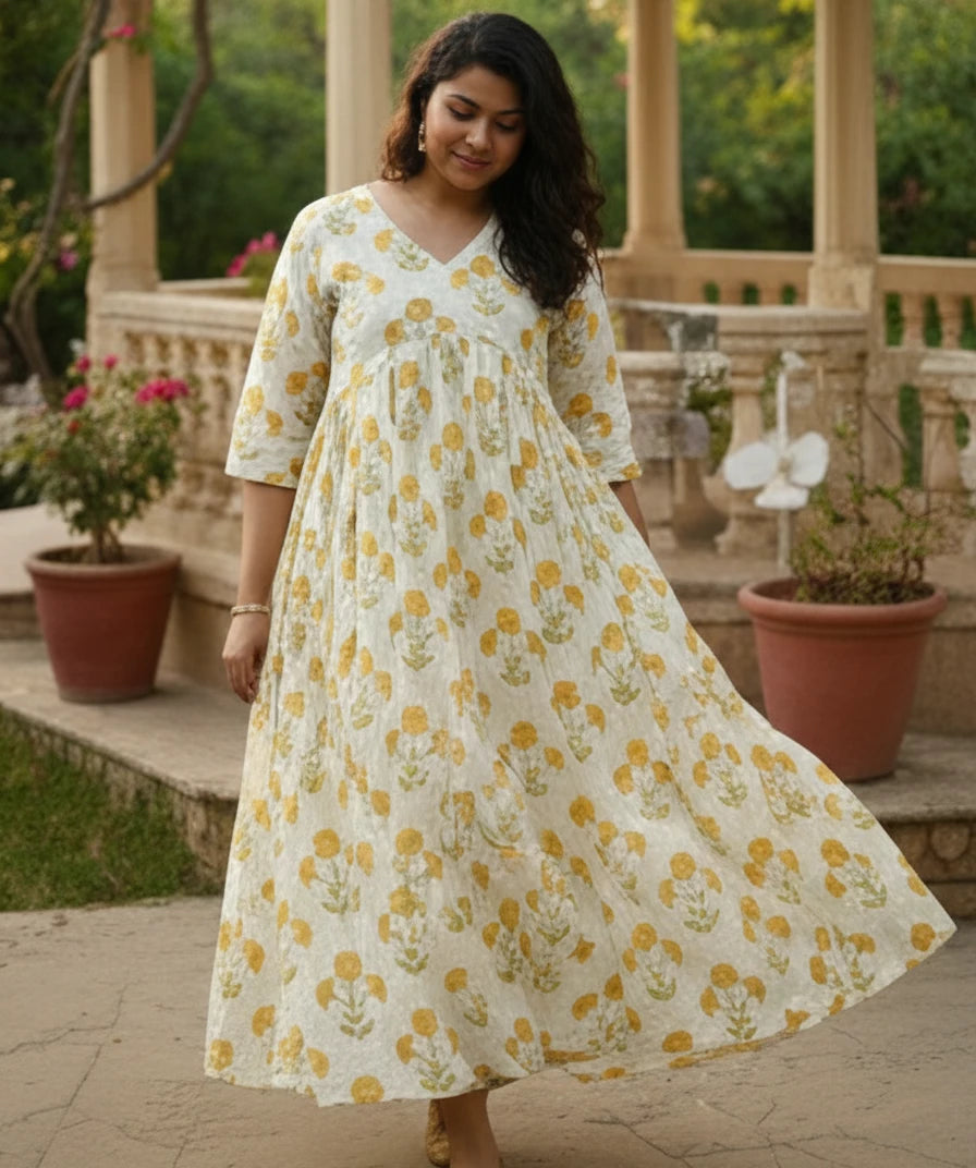 Woman wearing a yellow floral kurti top WITH GREENERY IN BACKGROUND