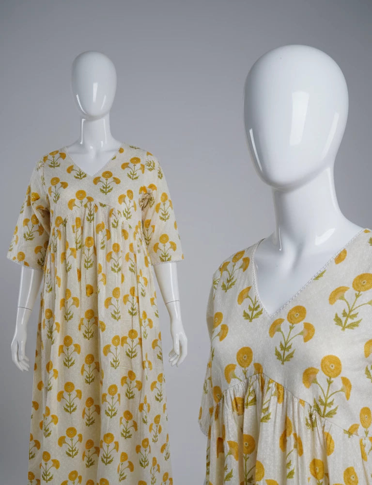Two mannequins wearing yellow office wear kurti top against a gray background